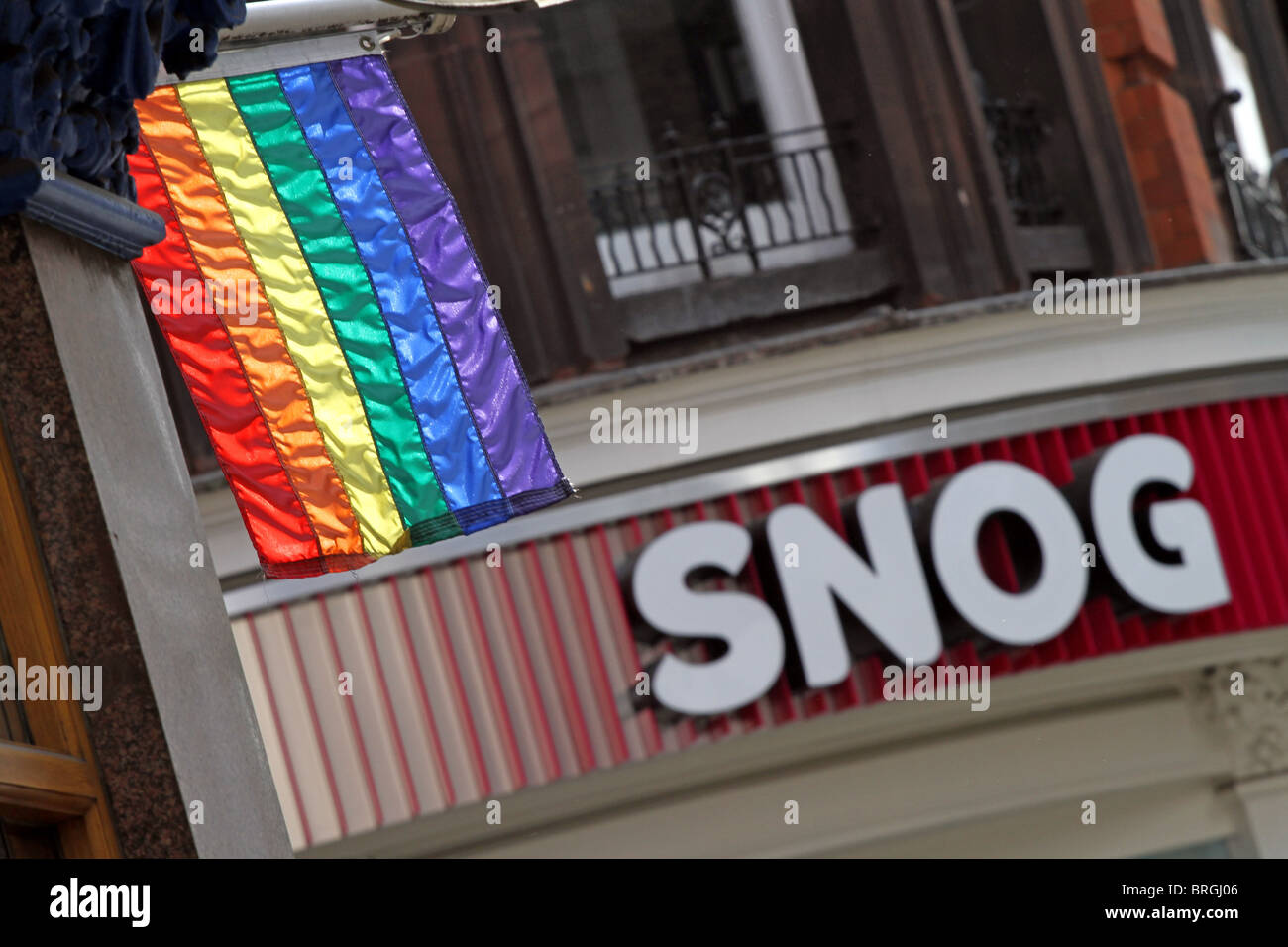 Gay rainbow flag and snog shop sign in the gay village in Soho, London, England Stock Photo