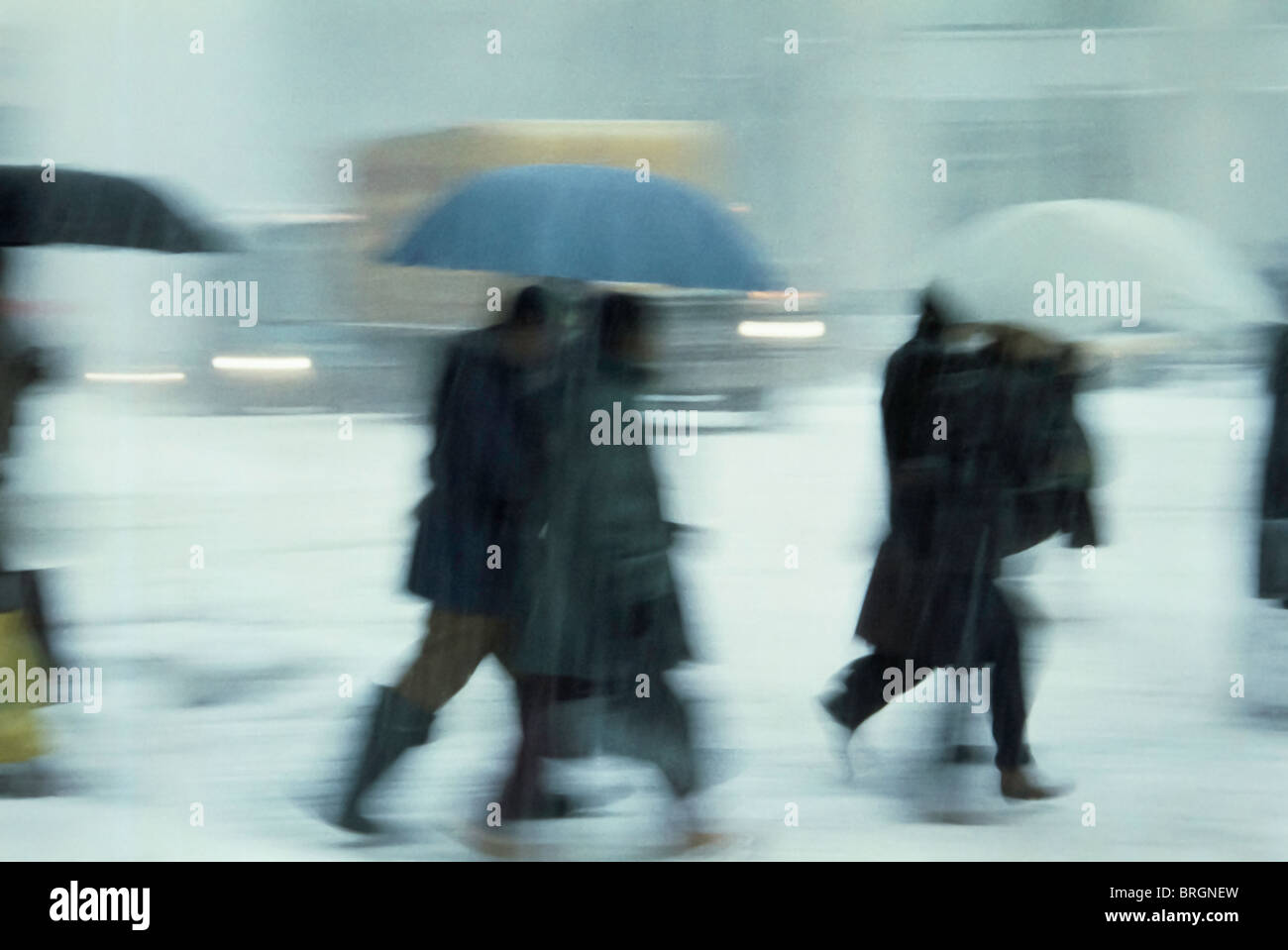 Pedestrians under Brollies and Traffic In Snowstorm, NYC  retro 1990s Stock Photo