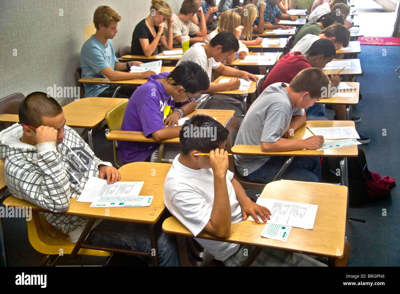 A multiracial Southern California high school class takes a multiple choice test, marking the answers on a Scantron card. Stock Photo