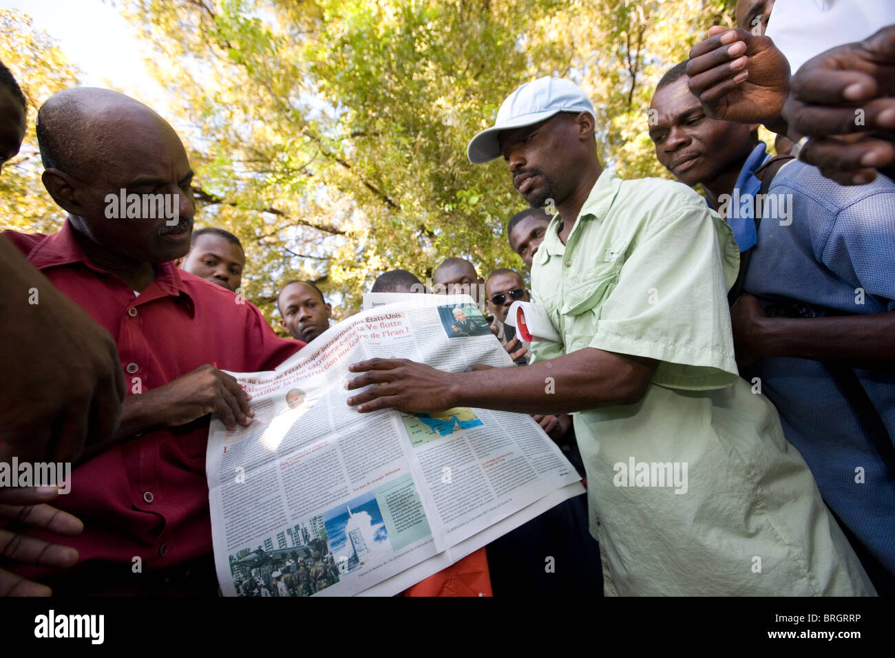Men holding a newspaper in Plaza Champ de Mars, Port au Prince, Haiti. Stock Photo