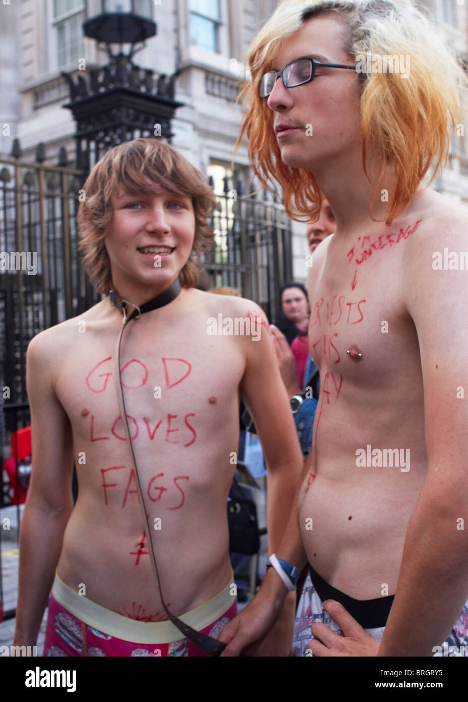 Two teenage boys strip naked and pretend to offer themselves to the Pope  during a 10,000 strong march through Central London Stock Photo - Alamy