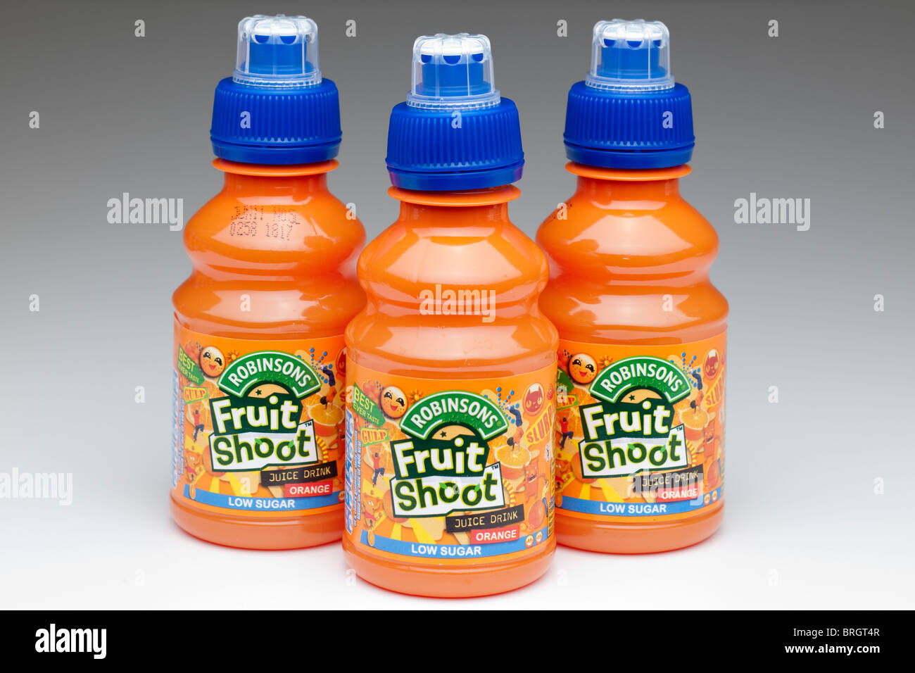 Three plastic bottles of Robinson's Fruit Shoot orange juice drink made from concentrate Stock Photo