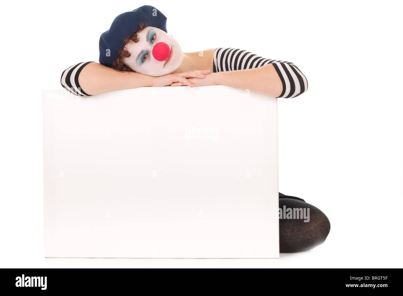 Young woman wearing clown face holding billboard isolated on white Stock Photo