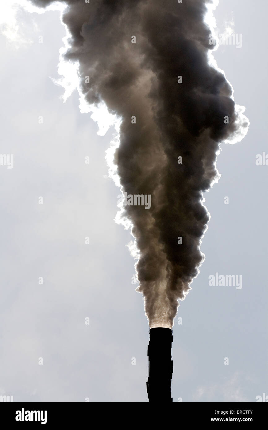 Industrial smokestack venting hot flue gases. Stock Photo