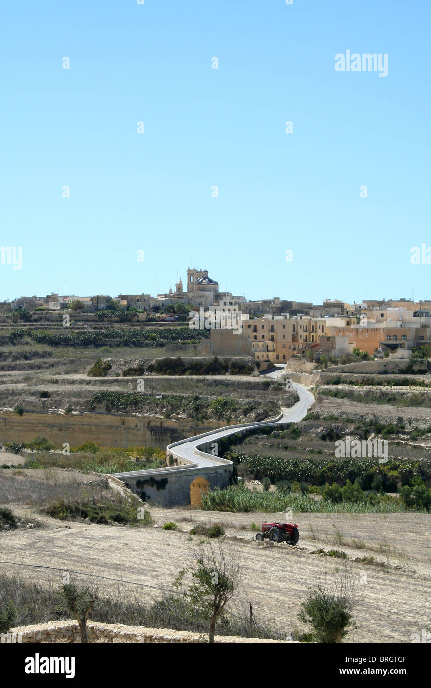 A winding road leading to a small town in Gozo off Malta Stock Photo