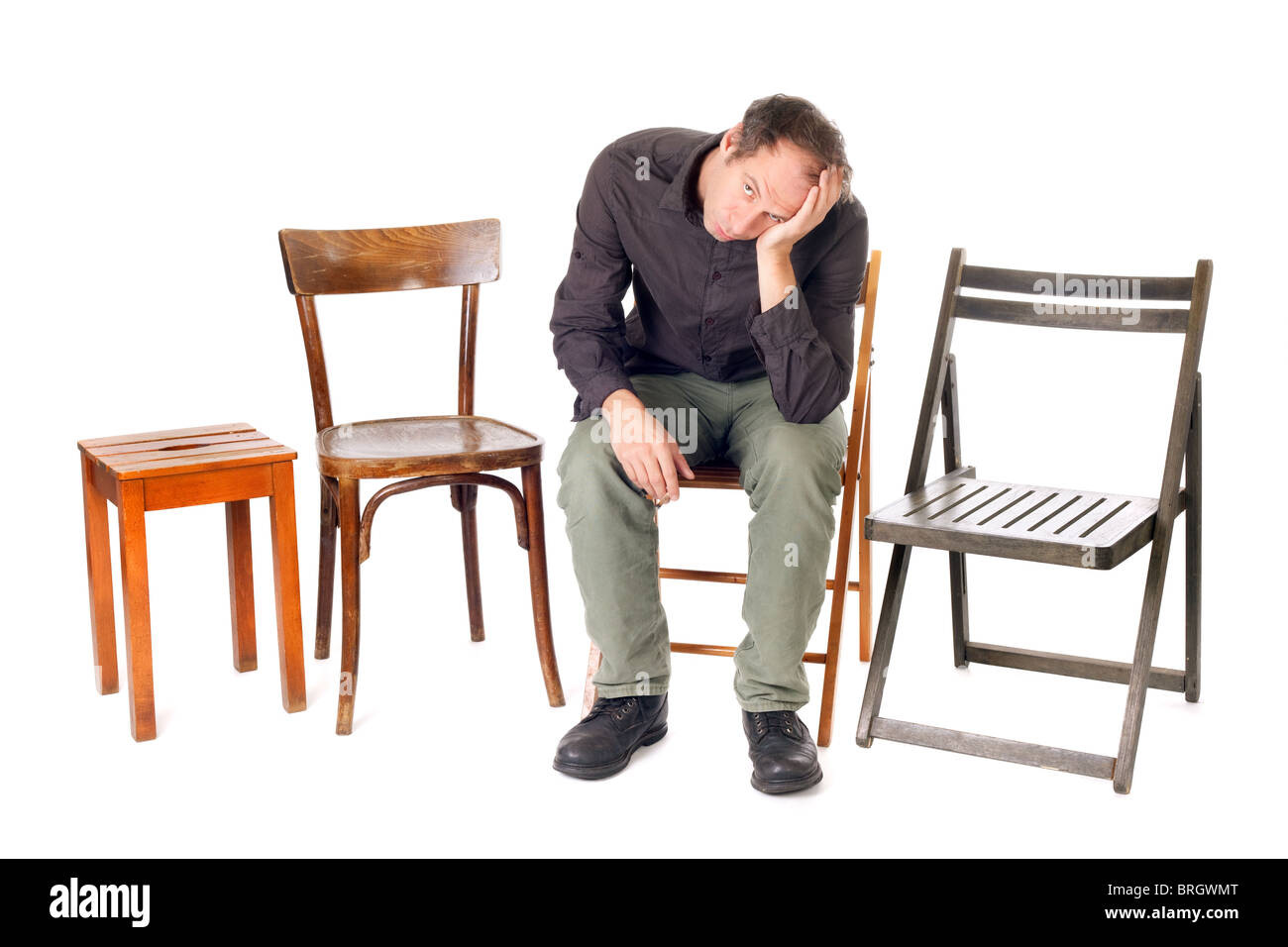 sad man sit on chair and thinking about problems Stock Photo