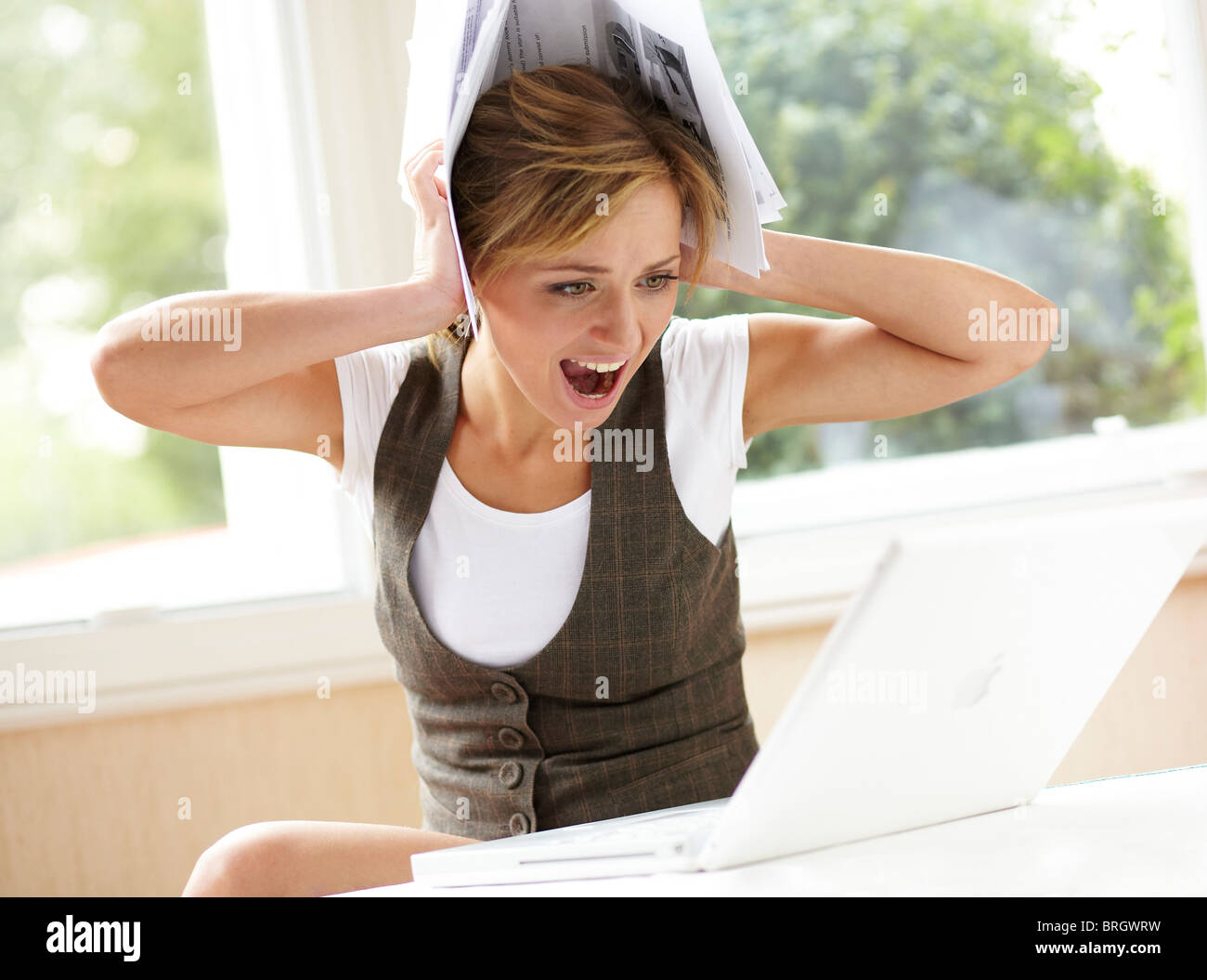 Stressed girl looking at bills Stock Photo