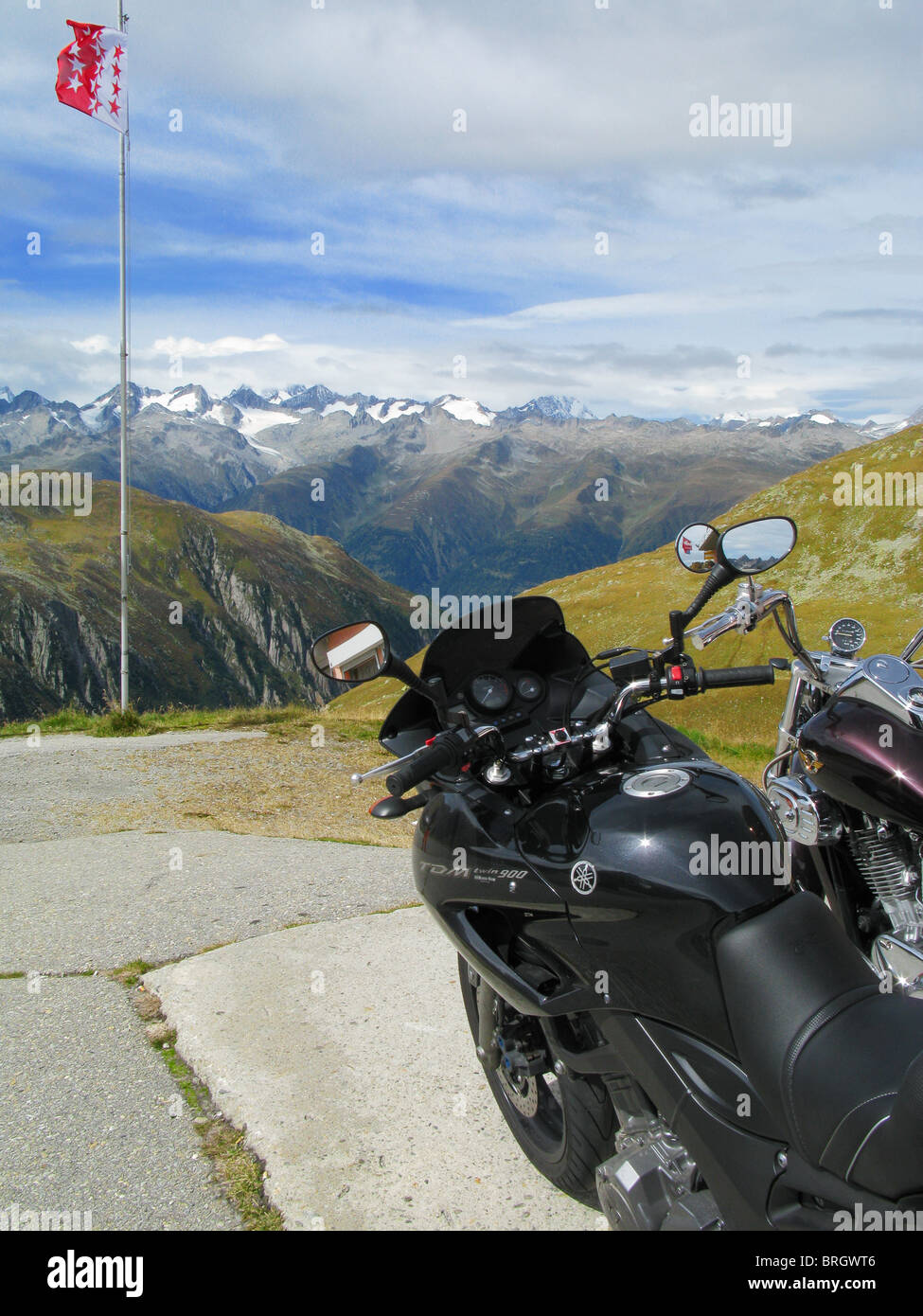 Motorcycles on the parking lot on the top of the Nufenen Pass, Valais, Switzerland Stock Photo