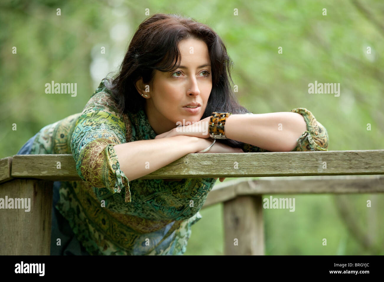 pensive woman relaxing in park at springtime Stock Photo