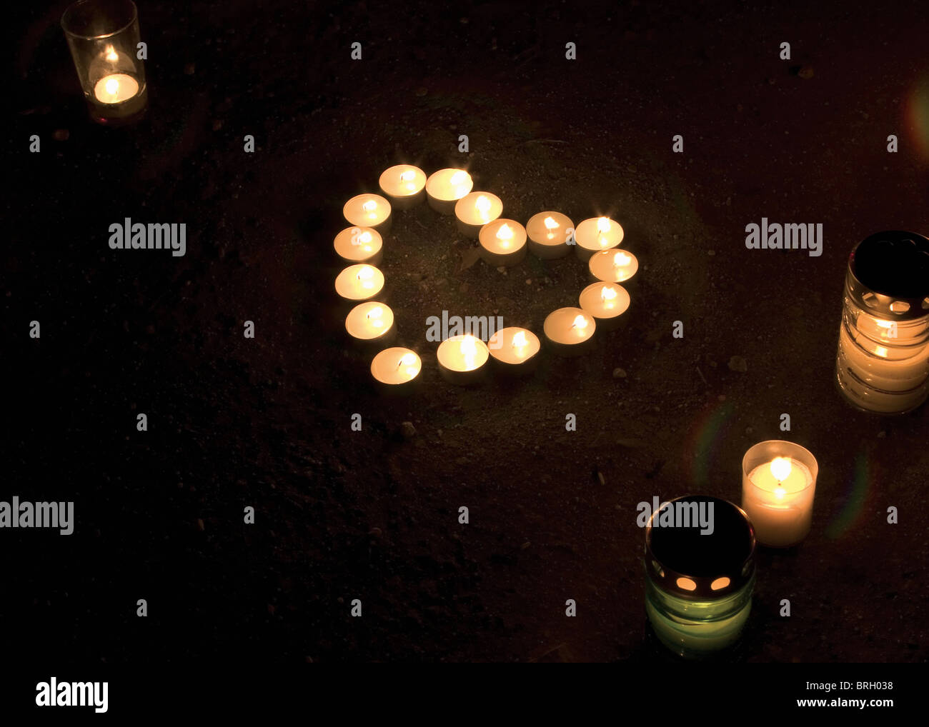 Lit candles in heart shape on the street after dead of pope John Paul