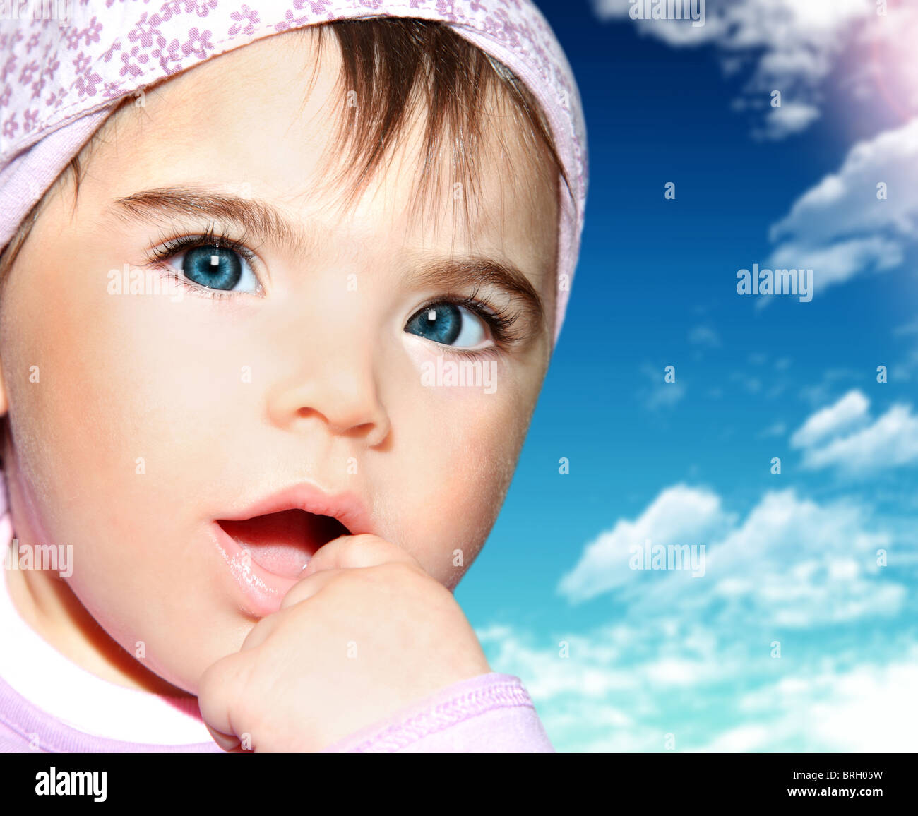 Little girl closeup portrait over blue sky Stock Photo - Alamy