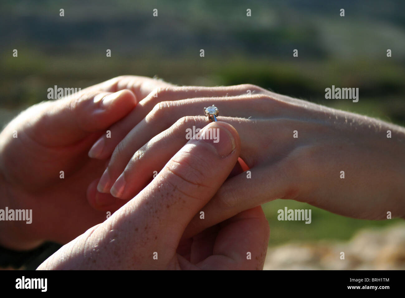 putting on an engagement ring Stock Photo