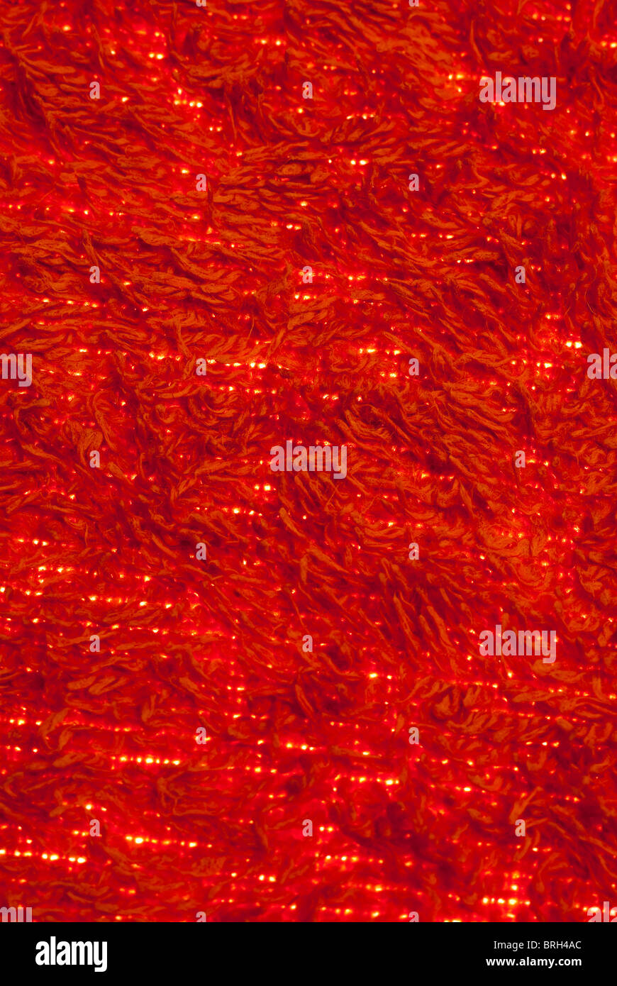Red Towelling background with light showing through Stock Photo