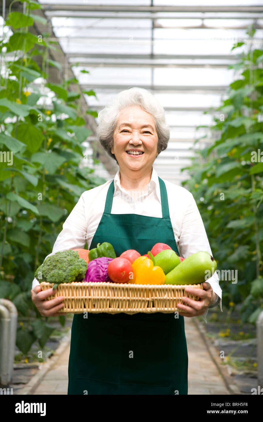 Farmer holding vegetables in modern farm Stock Photo - Alamy