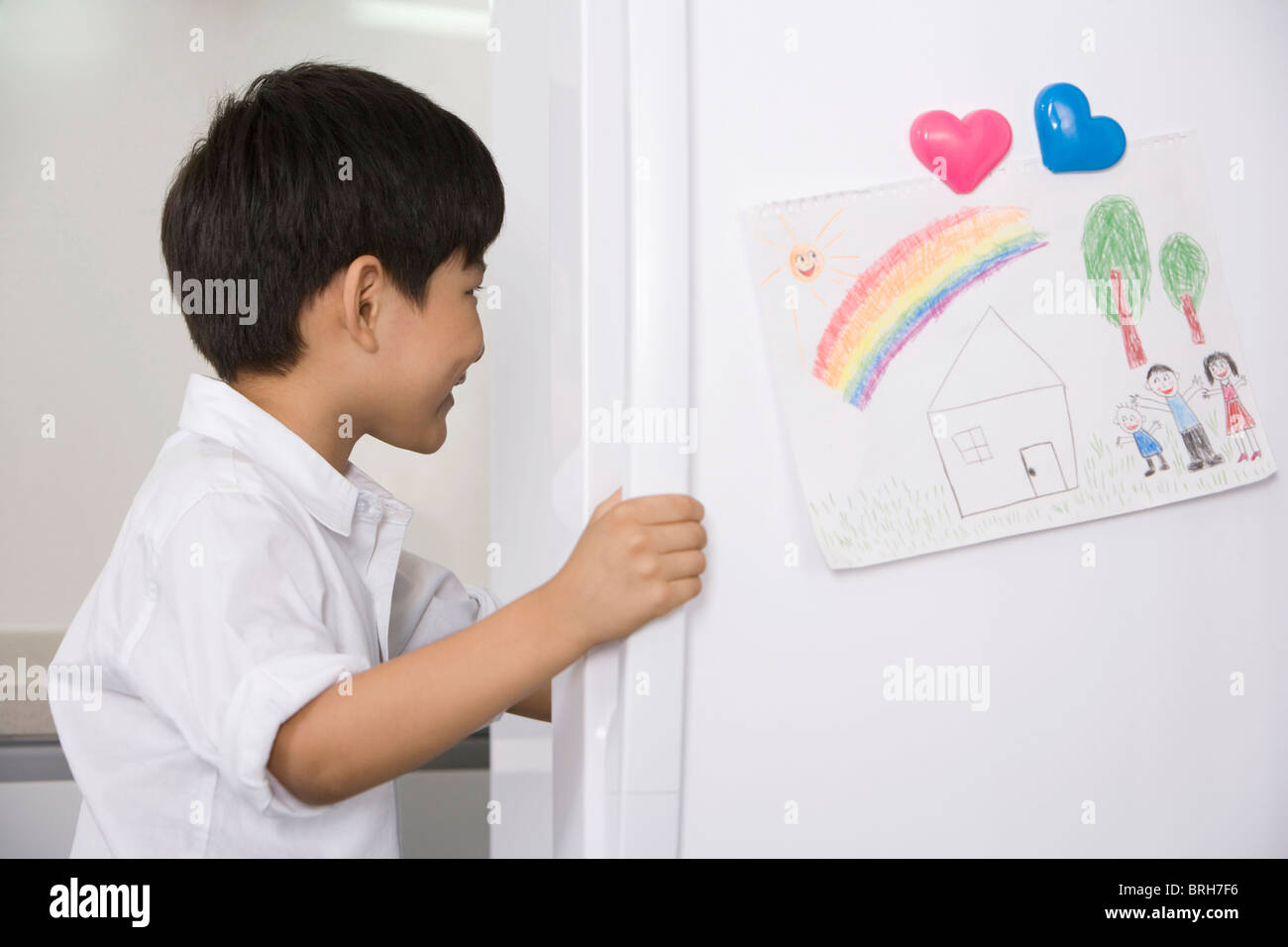 Young boy opening refrigerator Stock Photo
