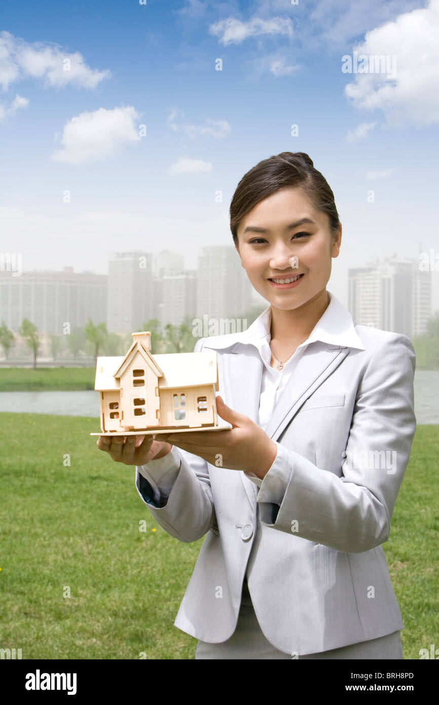 Woman holding a model house Stock Photo
