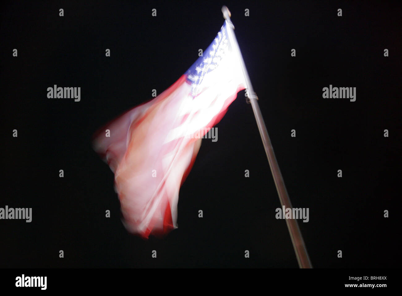 Blurred image of American flag fluttering in the wind. Stock Photo