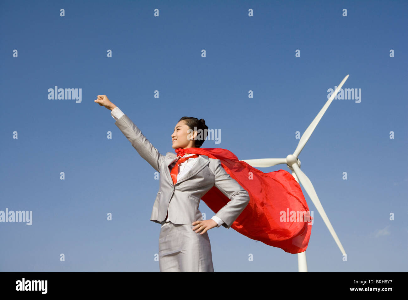 Everyday hero in front of wind turbines Stock Photo