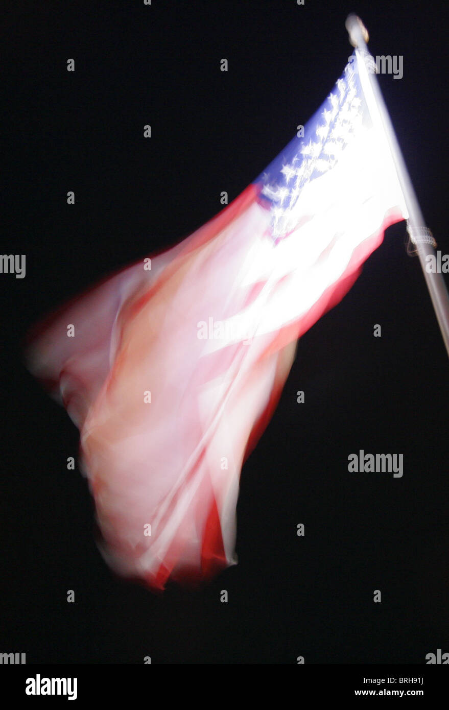 Blurred image of American flag fluttering in the wind. Stock Photo