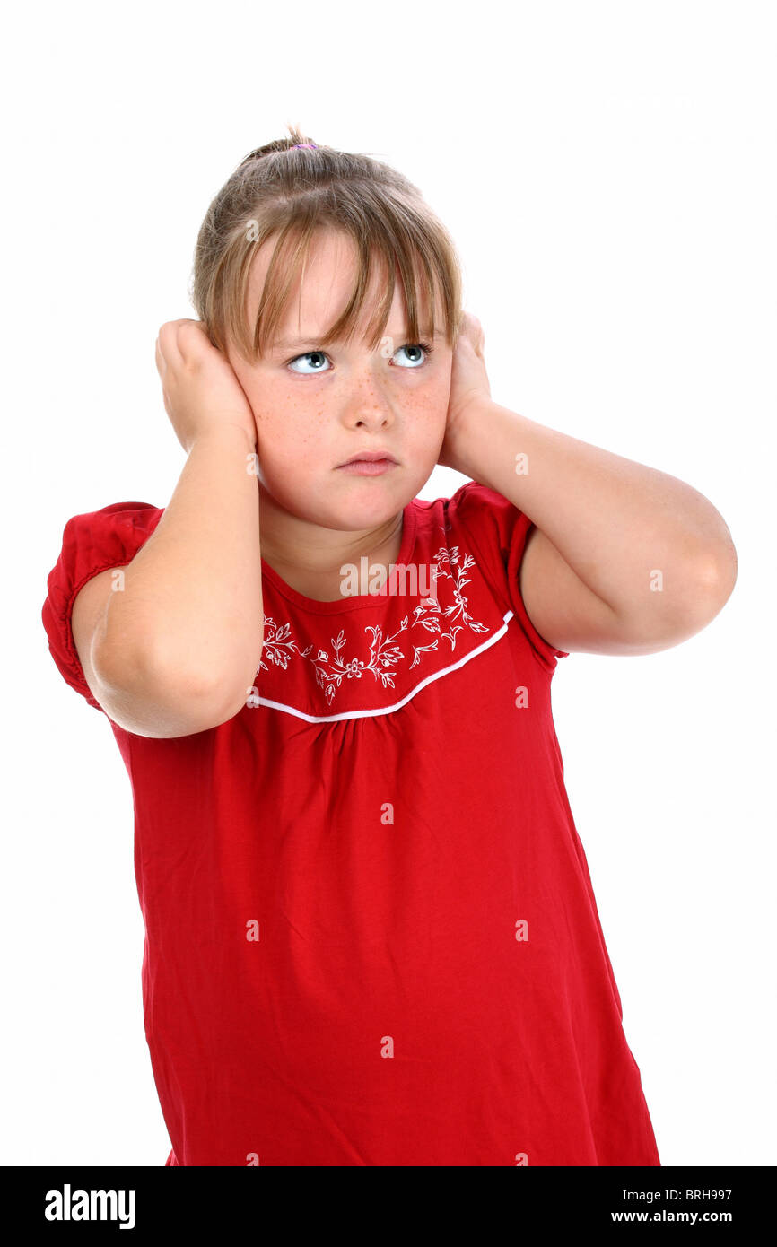 Small girl holding her ears with her hands so that she can't listen Stock Photo