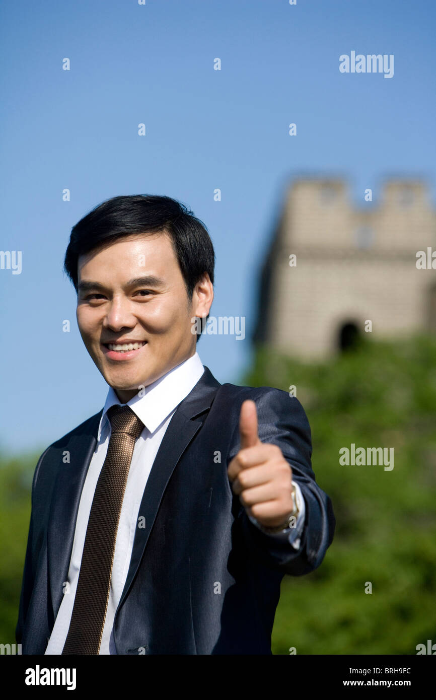 Businessman on the Great Wall giving thumbs up Stock Photo Alamy