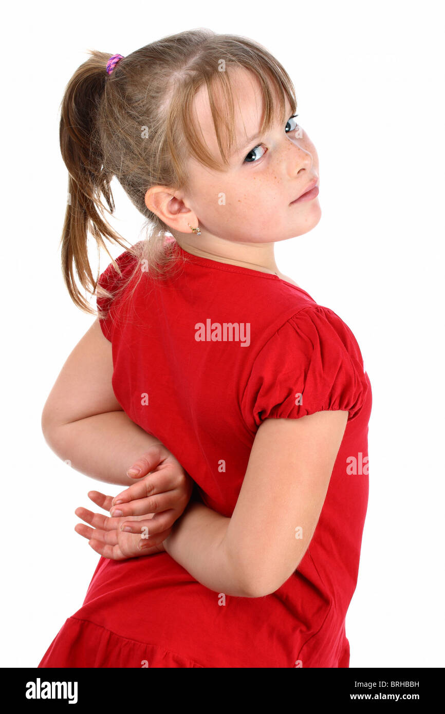 Small girl dressed in red looking over her shoulder isolated on white Stock Photo