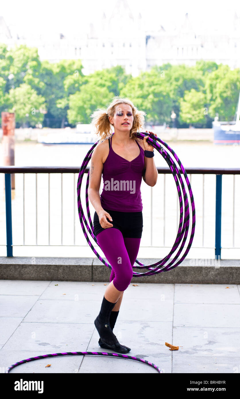 Hula Hooper Lisa Lotti performs on London's South Bank with Big Ben in the background. Stock Photo