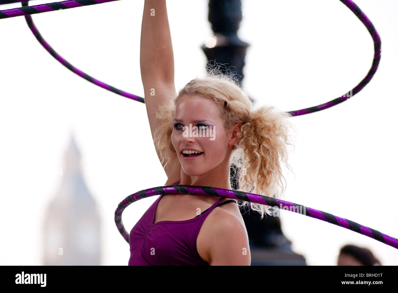Hula Hooper Lisa Lotti performs on London's South Bank with Big Ben in the background. Stock Photo