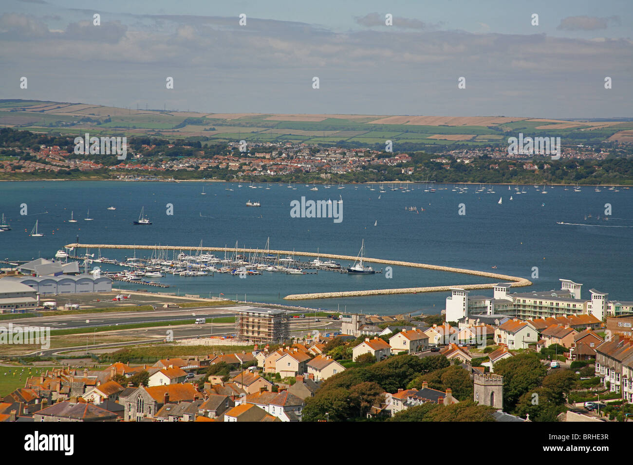 Looking west from the Isle of Portland over Portland harbour and the town of Fortuneswell, Dorset, England UK Stock Photo