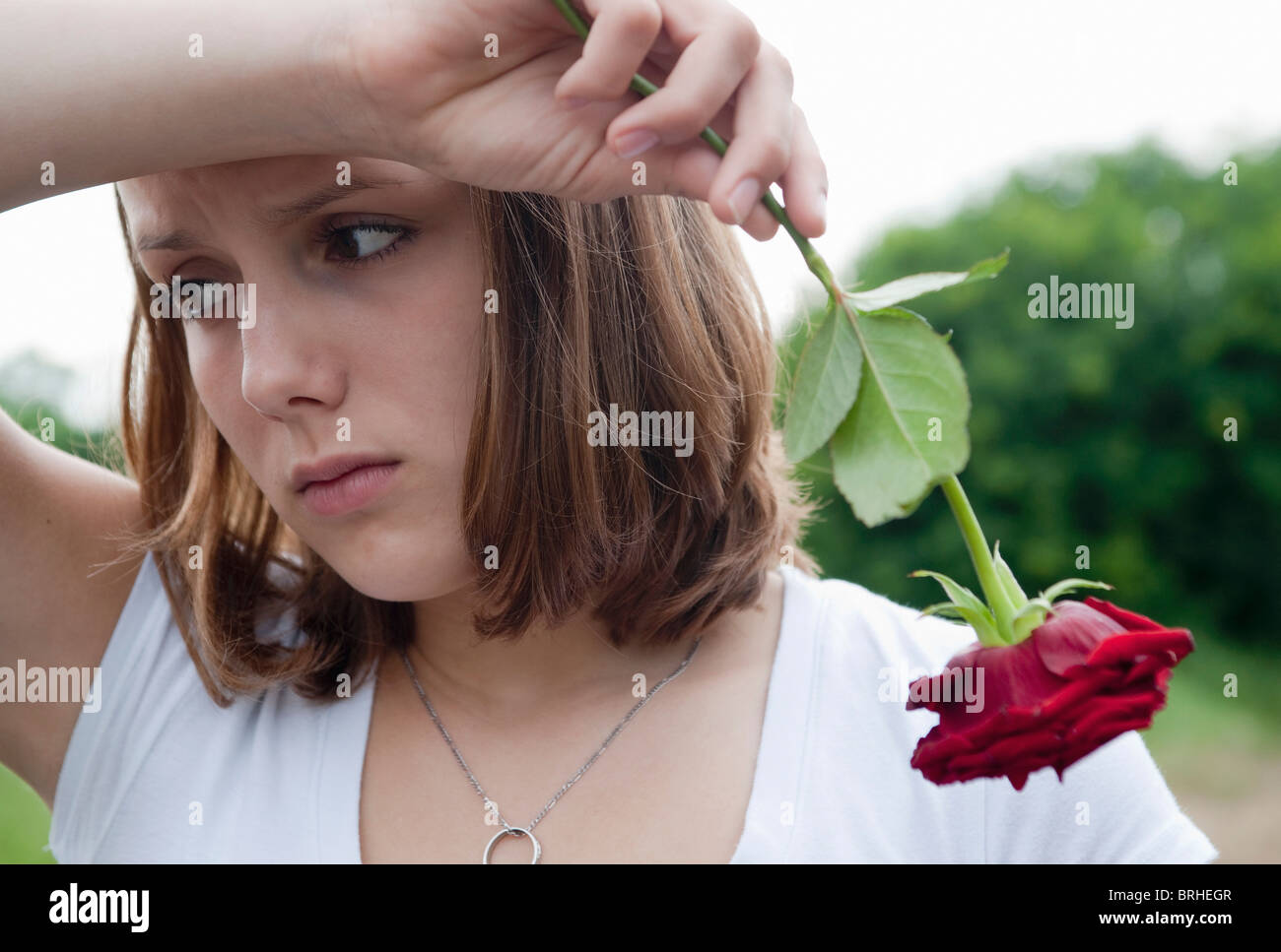 Teenage Girl Holding a Red Rose Stock Photo - Alamy