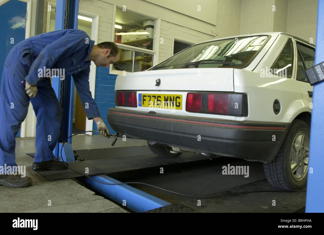 A mechanic performs an emissions test on the exhaust fumes as part of