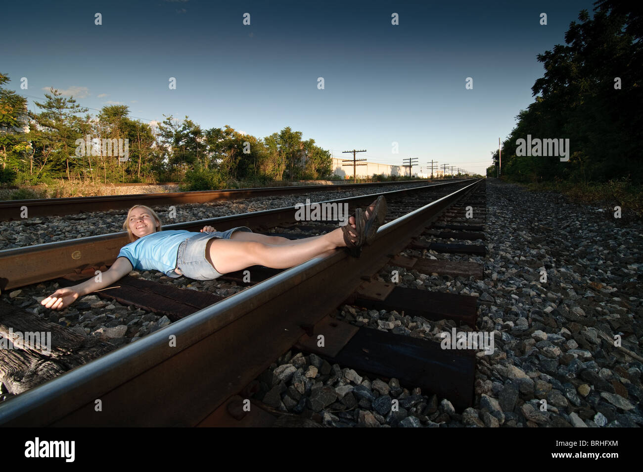 Girl on a train track Stock Photo