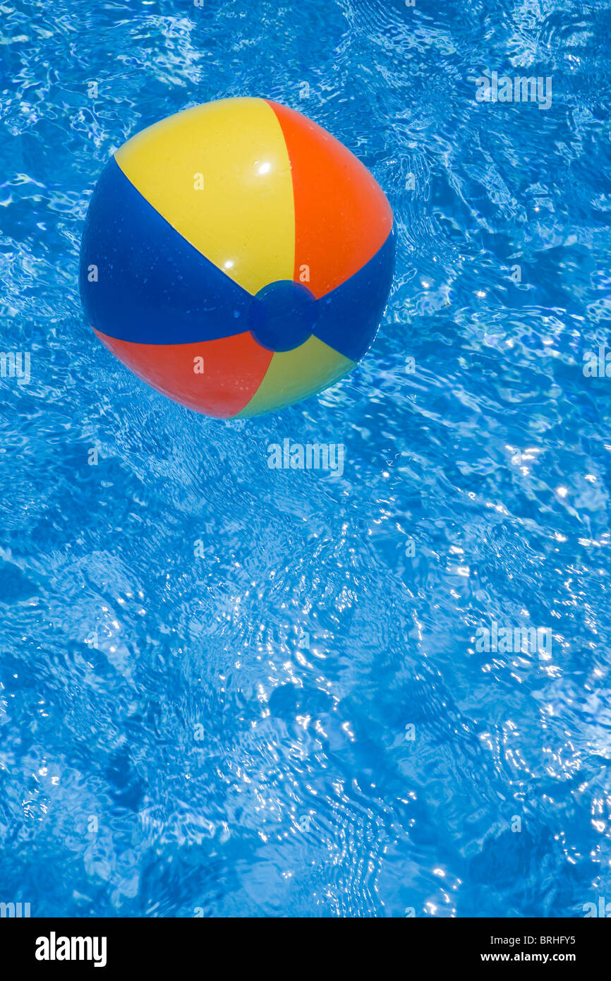 Beach ball in a sparkling blue swimming pool Stock Photo Alamy