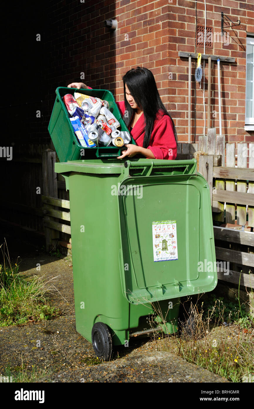 woman emptying recyclables into a wheeled bin england uk Stock Photo