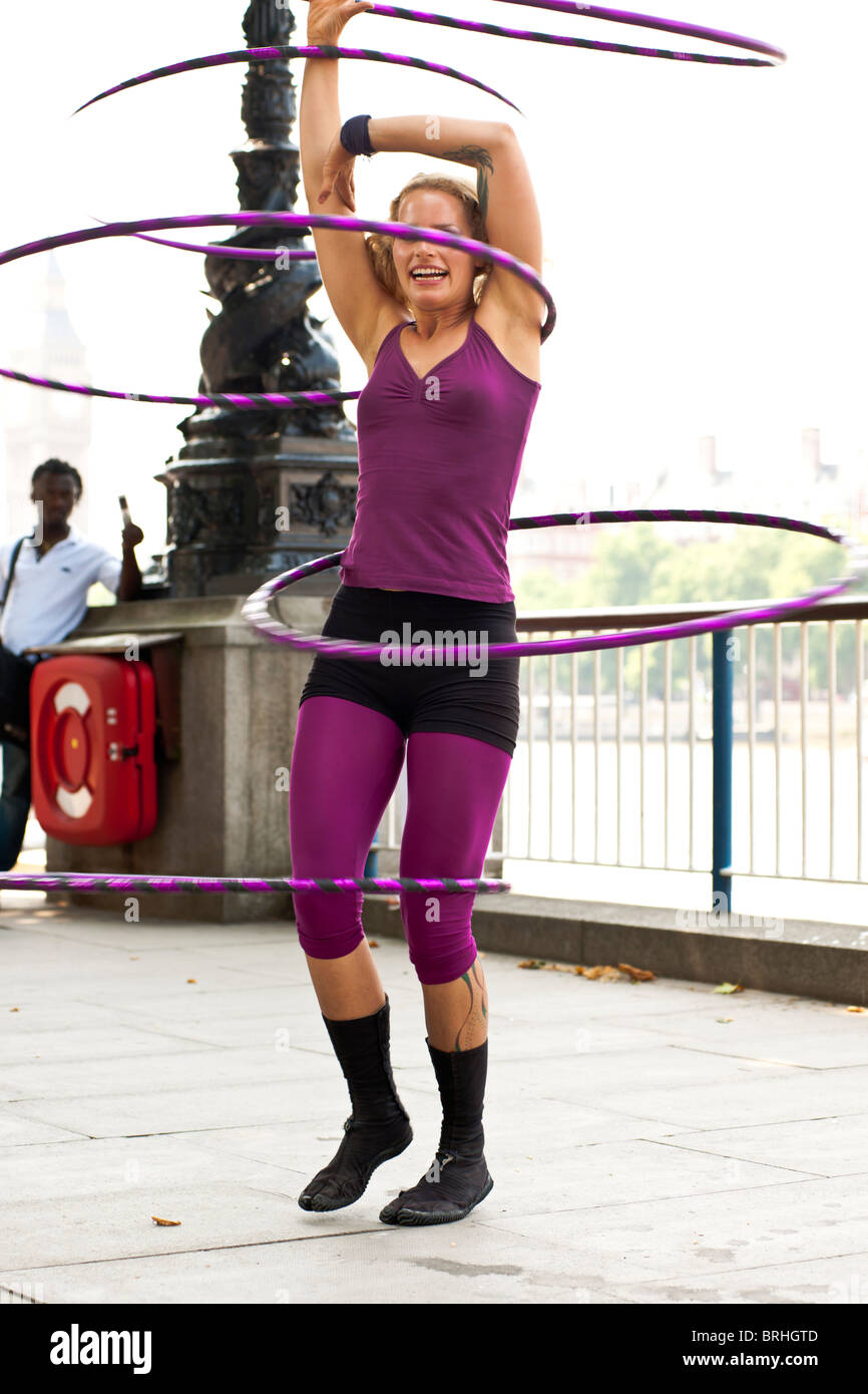 Hula Hooper Lisa Lotti performs on London's South Bank with Big Ben in the background. Stock Photo