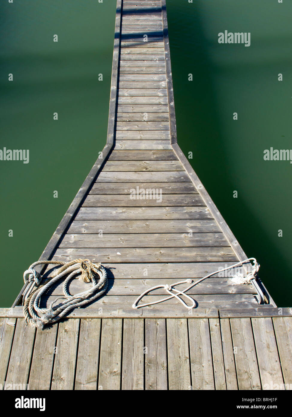 A wooden jetty with tie ropes ready in the harbour  at St Martin de Re on the French idsland of Ile de Re Stock Photo