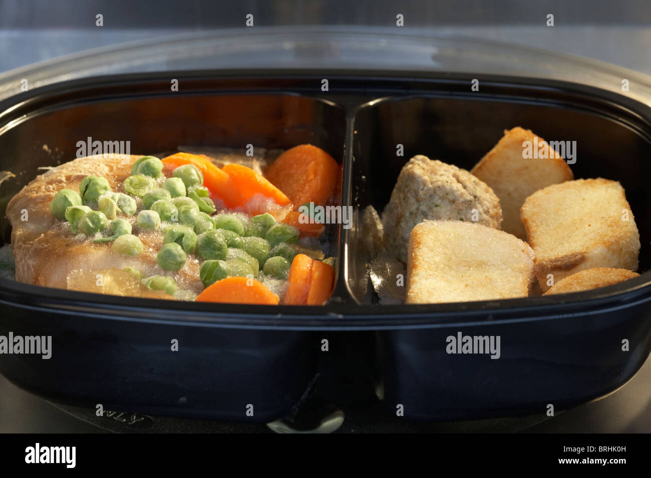 frozen microwave chicken dinner meal for one in a microwave ready to cook Stock Photo