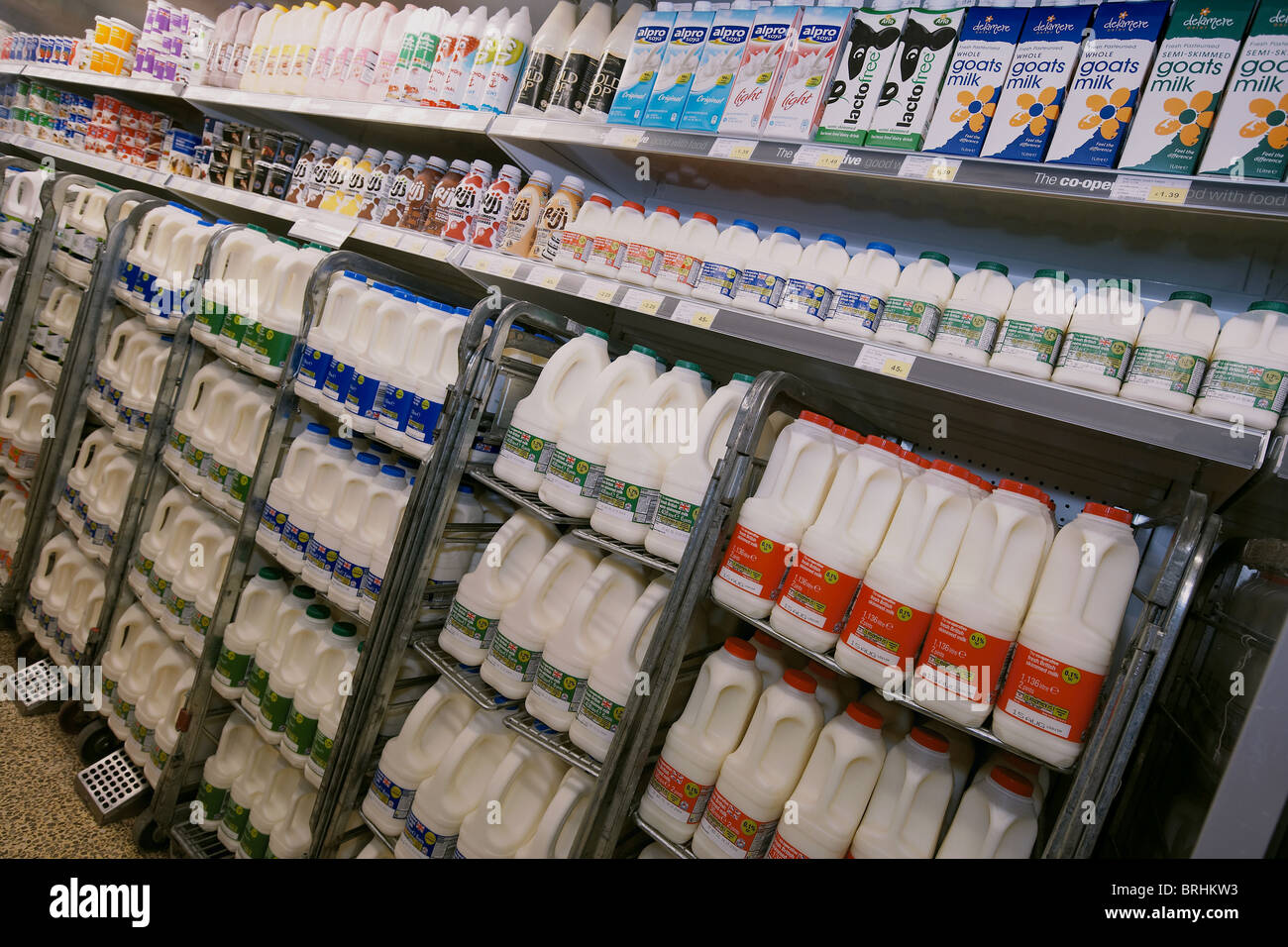 Milk, goats milk and dairy products for sale stacked on a supermarket
