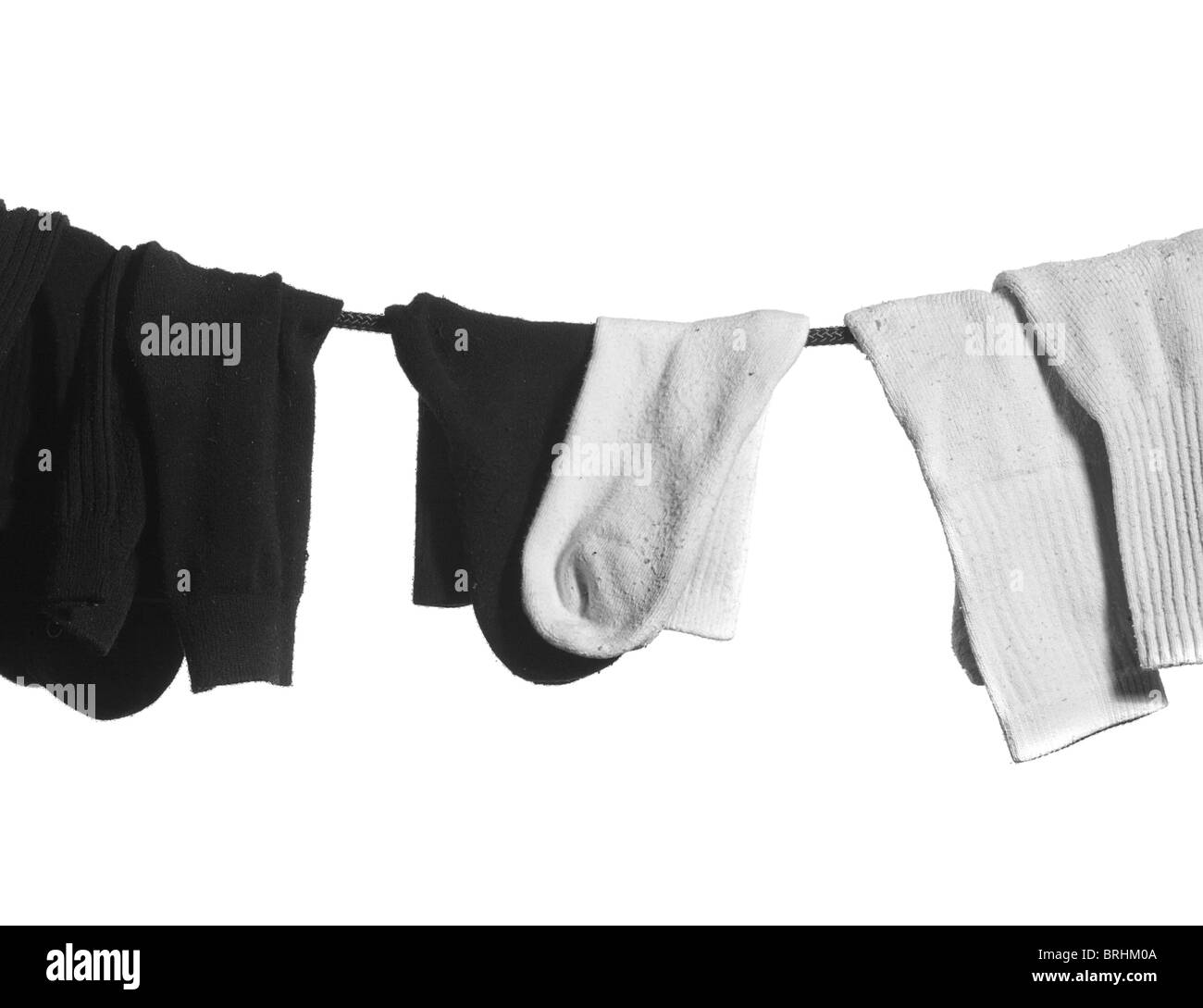 rope with hanging socks: black on the left side and white on the right ...