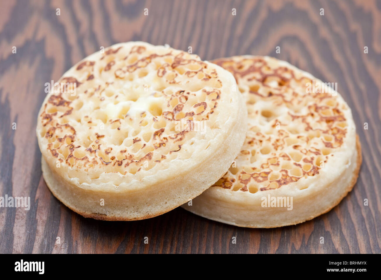 Freshly toasted crumpet on a wooden tray Stock Photo