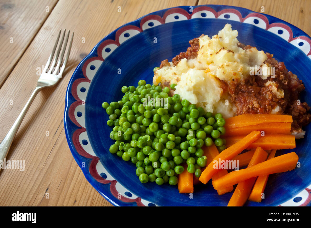 Home cooking : Shepherds Pie with peas and carrots. Stock Photo