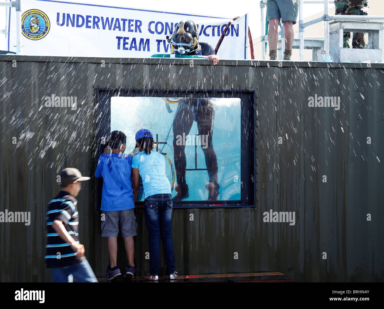 Kids watching US Navy underwater construction team demonstration Stock Photo