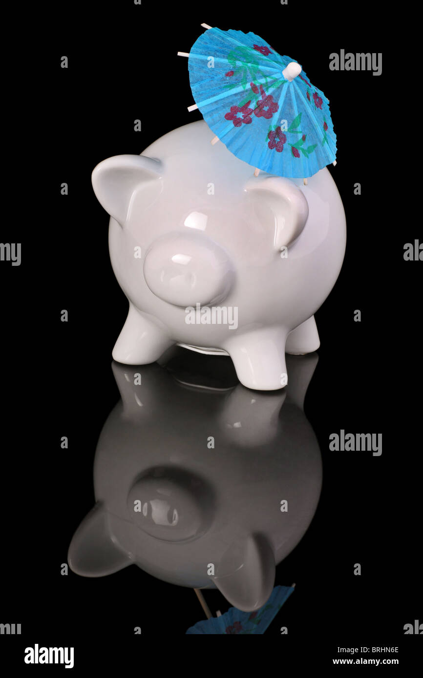 piggy bank with parasol, concept of summer savings. Stock Photo