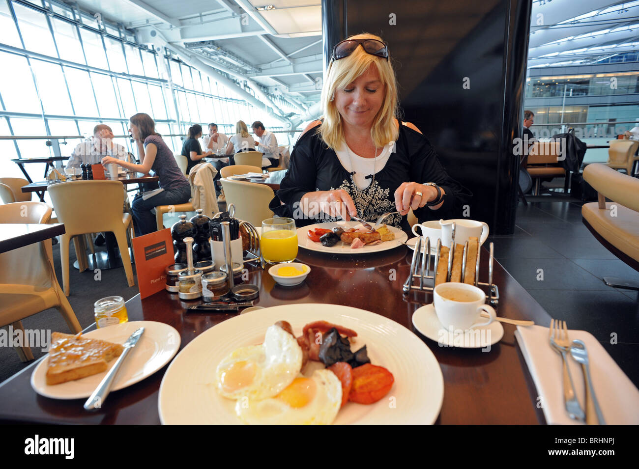 A woman enjoys breakfast in Gordon Ramsay's 'Plane Food' restaurant in