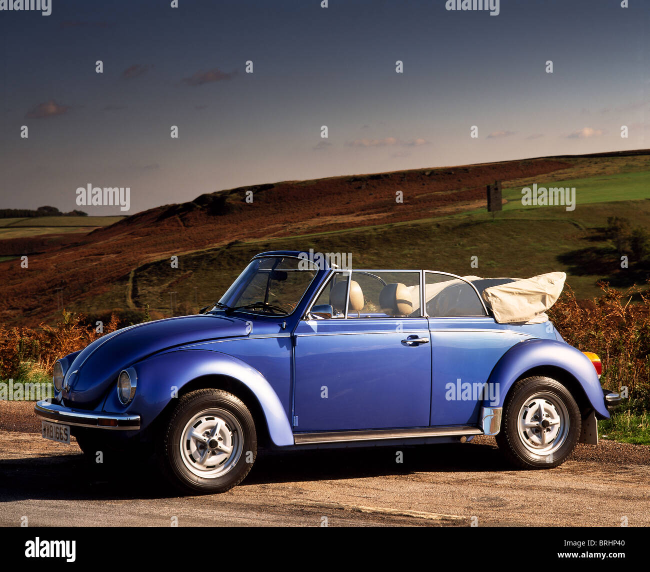 1975 VW Beetle 1303 Cabriolet parked on country road, front view, roof down Stock Photo