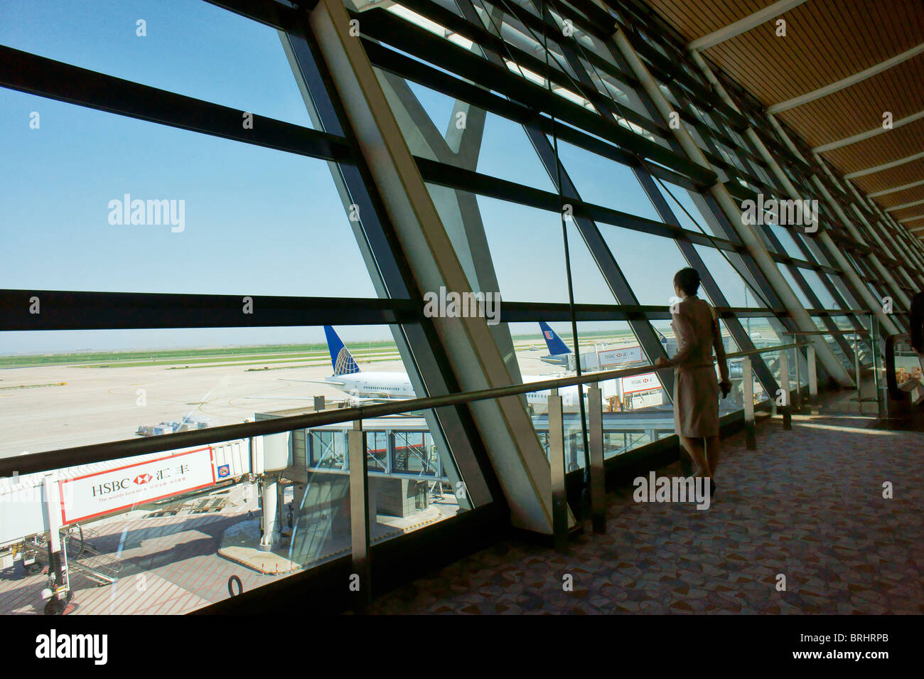 Shanghai, China. Observation deck window onto runway apron. Departure lounge, Pudong International Airport, Shanghai Stock Photo