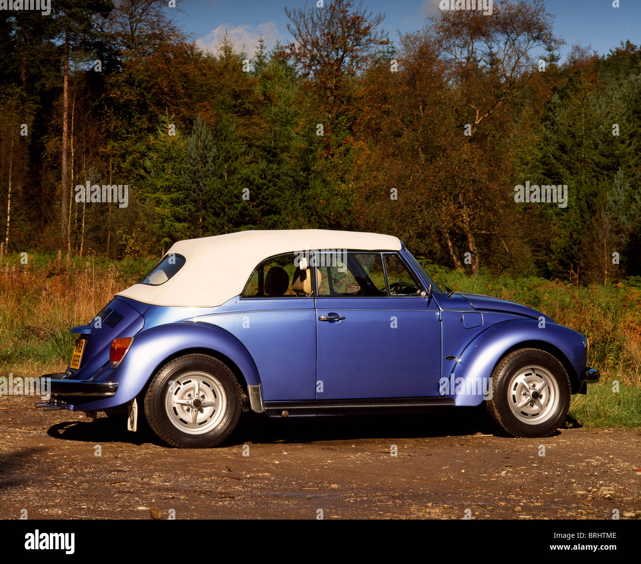 1975 VW Beetle 1303 Cabriolet parked on country road, side view, roof up Stock Photo