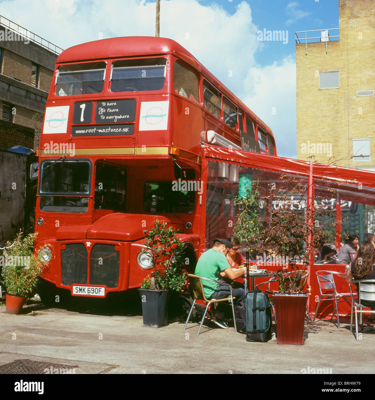A red double-decker vintage route master bus being used as Rootmaster cafe and restaurant Shoreditch London UK  KATHY DEWITT Stock Photo
