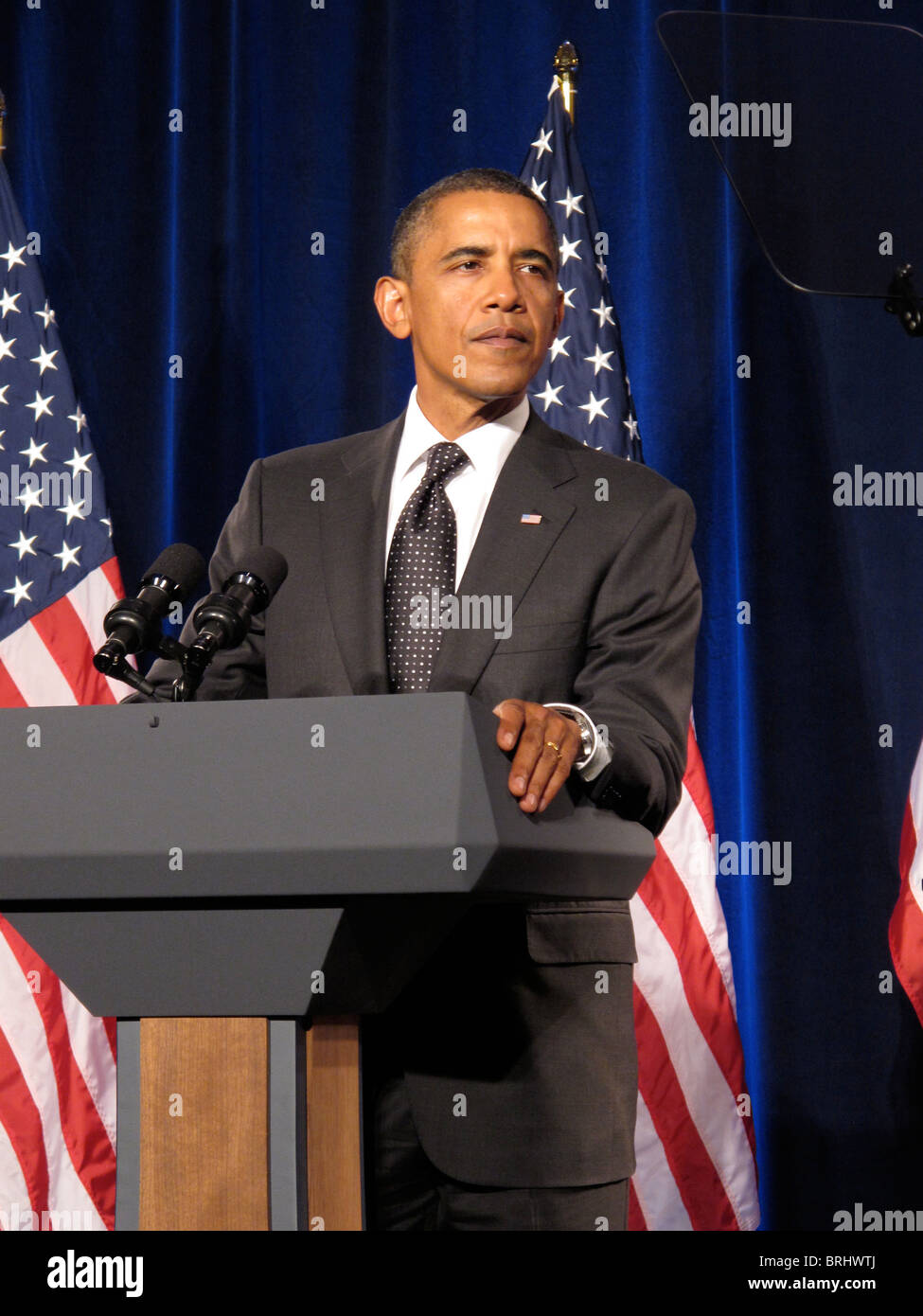 Portrait of US President Barack Obama with the Flag of The United States of America Behind Him Stock Photo