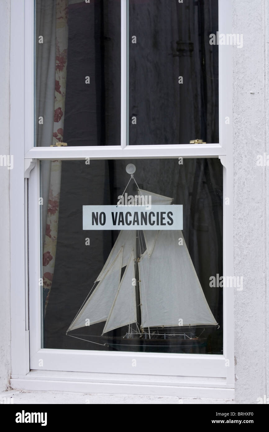 A No Vacancies sign in a Cornish guest house window Stock Photo